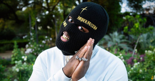 Drill rapper smiling with gold teeth